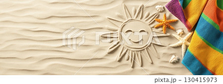 Smiling sun drawing on the sand of a beach with a colorful striped beach towel and starfishes, evoking summer holidays, relaxation, and travel destinations 130415973