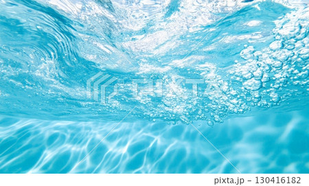 Dynamic view of water surface showcasing ripples and bubbles created by raindrops. Light reflections dance underwater, creating a serene and captivating aquatic scene 130416182
