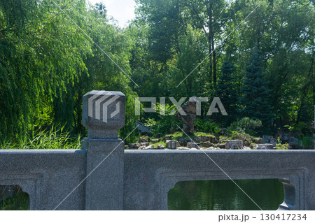 chinese garden with pond and stone bridge in the morning. Summer landscape 130417234