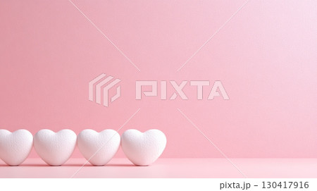 Four white hearts are standing on a pink surface with a pink background, creating a romantic atmosphere perfect for valentine's day, mother's day, or spring celebrations 130417916