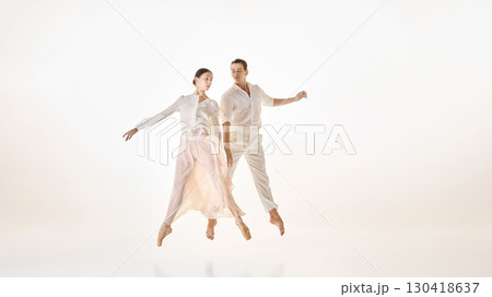 Ballet duo in midair jump captured in synchronized grace 130418637