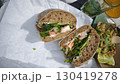 Fresh sandwich with shrimp, cream cheese and greens served with guacamole and lime 130419278