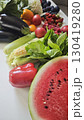 Colorful summer harvest of fresh fruits and vegetables on a white surface 130419280