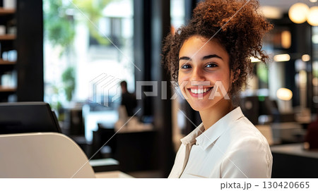 A bright and inviting scene featuring a cheerful young woman smiling in a stylish setting 130420665