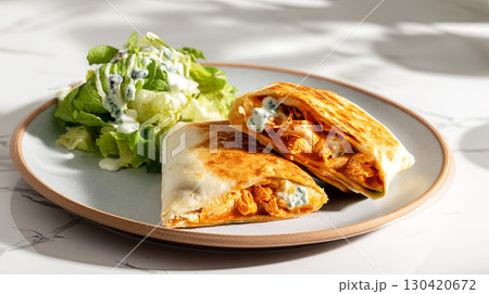 Delicious chicken wraps served with a fresh salad, perfect for a light meal or a snack 130420672