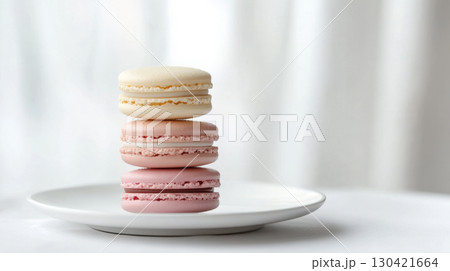 Pastel Macarons Stacked on White Plate with Pink Backdrop Pastel Macarons Stacked on White Plate with Pink Backdrop 130421664