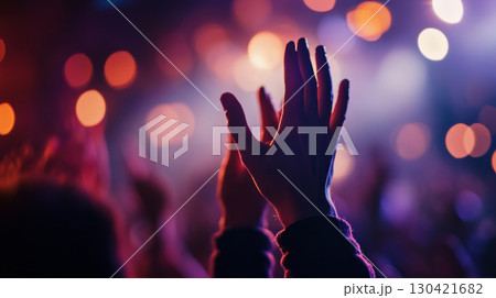 Raised Hands at Vibrant Concert with Colorful Stage Lighting 130421682