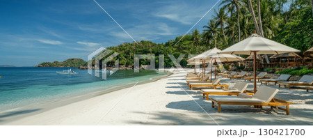 Tropical Beach Loungers with Umbrellas and Ocean View 130421700