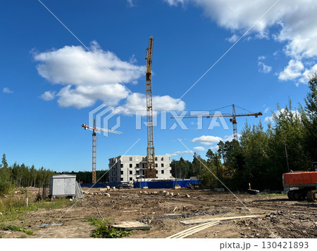 High-rise building under construction with tower crane at a busy construction site High-rise building under construction with tower crane at a busy construction site 130421893