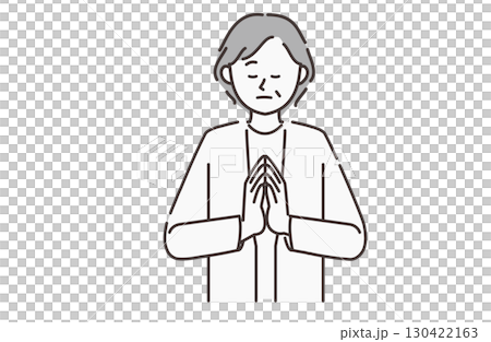 An elderly woman praying 130422163