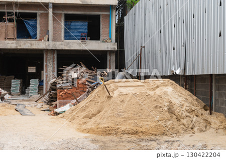 Building under construction with stacked materials Building under construction with stacked materials 130422204