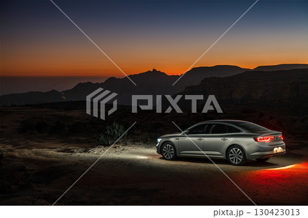Car parked in the desert at sunset, Saudi Arabia 130423013