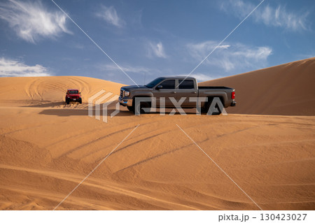 Pickup truck and SUV driving on desert dunes, Saudi Arabia 130423027