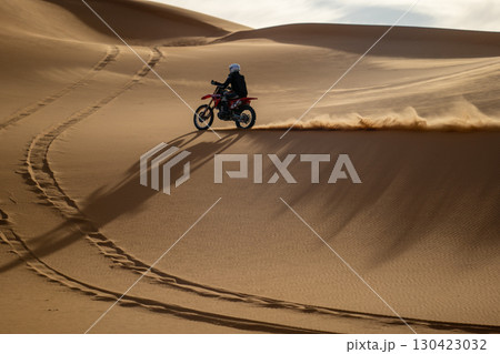 Motorbike riding on desert dunes, Saudi Arabia Motorbike riding on desert dunes, Saudi Arabia 130423032