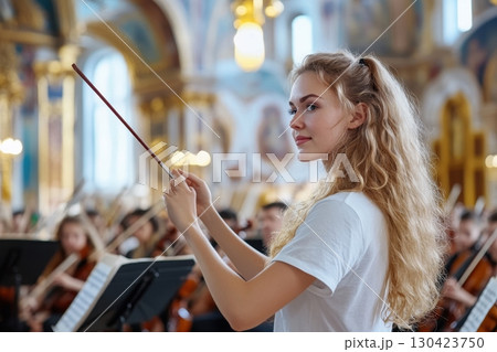 Young woman conducts an orchestra in a majestic hall, skillfully wielding her baton Young woman conducts an orchestra in a majestic hall, skillfully wielding her baton 130423750