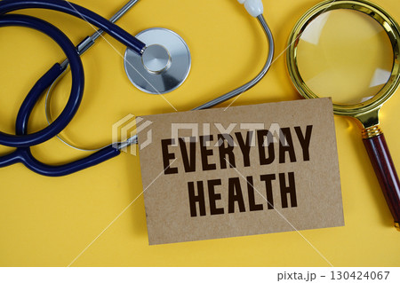 Everyday Health text on paper card with Stethoscope flat lay on yellow background Everyday Health text on paper card with Stethoscope flat lay on yellow background 130424067
