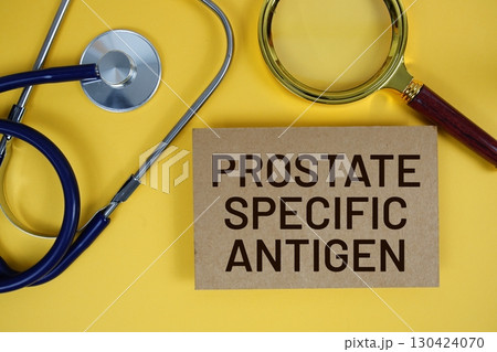 Prostate Specific Antigen (PSA) text on paper card with Stethoscope flat lay on yellow background 130424070
