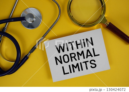 Within Normal Limits (WNL ) text on paper card with Stethoscope flat lay on yellow background Within Normal Limits (WNL ) text on paper card with Stethoscope flat lay on yellow background 130424072