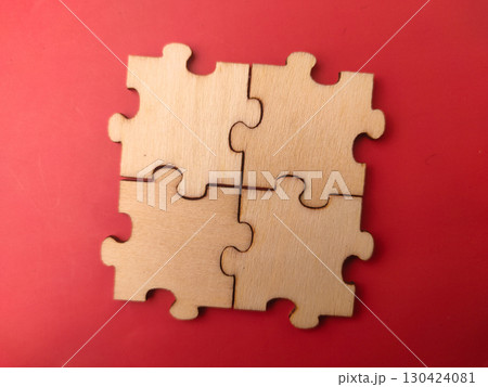 The image displays four blank, unfinished wooden jigsaw puzzle pieces. The image displays four blank, unfinished wooden jigsaw puzzle pieces. 130424081