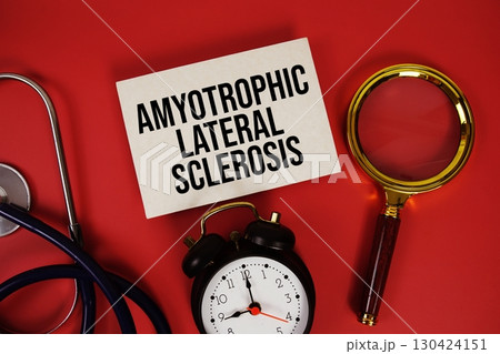 Amyotrophic Lateral Sclerosis text written on paper card with stethoscope, alarm clock and magnifying glass red background 130424151