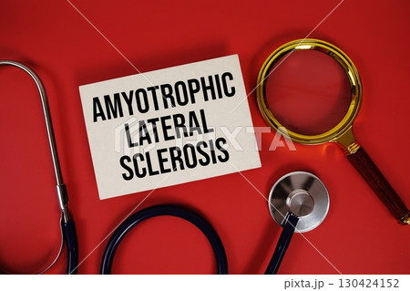 Amyotrophic Lateral Sclerosis text written on paper card with stethoscope and magnifying glass on red background 130424152