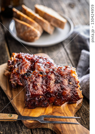 Pork BBQ glazed ribs on wooden cutting board. 130424959
