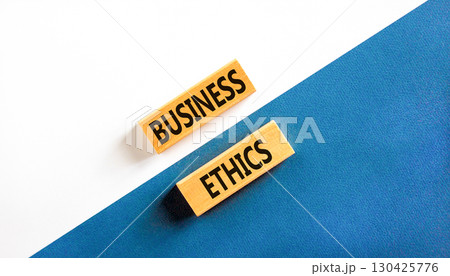Business ethics symbol. Concept words Business ethics on beautiful wooden blocks. Beautiful white and blue background. Business ethics concept. Copy space. Business ethics symbol. Concept words Business ethics on beautiful wooden blocks. Beautiful white and blue background. Business ethics concept. Copy space. 130425776