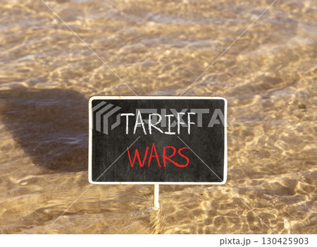 Trade tariff wars symbol. Concept word Tariff wars on beautiful black blackboard. Beautiful Red sea water background. Black blackboard. Business trade tariff wars concept. Copy space. 130425903
