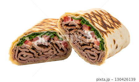 Appetizing shawarma with juicy beef and fresh vegetables, cut in half and shown in a cross-section. Ideal image for menus, food delivery sites and culinary blogs. 130426139
