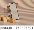 Smartphone placed beside shopping cart filled with shipping boxes representing ecommerce logistics and online shopping efficiency 130426701