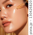 Radiant skin close-up with dropper applying nourishing serum for glowing complexion and luxury skincare concept 130426820