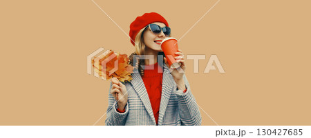 Autumn portrait of beautiful smiling young woman with yellow leaves, cup of coffee drink Autumn portrait of beautiful smiling young woman with yellow leaves, cup of coffee drink 130427685