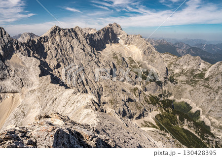 Scenic View Of Zugspitze And Jubilee Ridge From Via Ferrata Alpspitze: Rugged Rocky Peaks Of The Bavarian Alps Under Clear Blue Sky 130428395