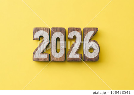 Wooden numbers 2026 on a yellow background. Concept 2026 New Year. 130428541