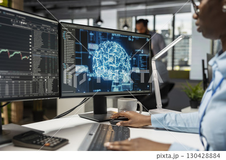 Trader in office utilizing AI LLM chatbot for instant market analysis and trading tips. Financial expert integrating AI analytics to monitor and react to global financial news Trader in office utilizing AI LLM chatbot for instant market analysis and trading tips. Financial expert integrating AI analytics to monitor and react to global financial news 130428884