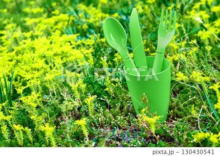Green and yellow picnic.Plastic dinnerware set.Cup,fork,knife,spoon Green and yellow picnic.Plastic dinnerware set.Cup,fork,knife,spoon 130430541