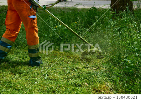 Landscaping.Professional grass cutting on green meadow with lawn mower Landscaping.Professional grass cutting on green meadow with lawn mower 130430621
