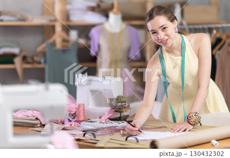 Girl seamstress to draw using patterns Girl seamstress to draw using patterns 130432302