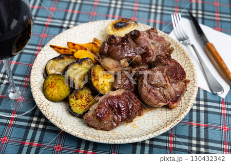 Tasty sliced grilled beef served with potatoes and eggplant 130432342