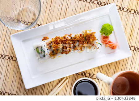 Plate is filled with crunch California rolls with fried puffed rice Plate is filled with crunch California rolls with fried puffed rice 130432849