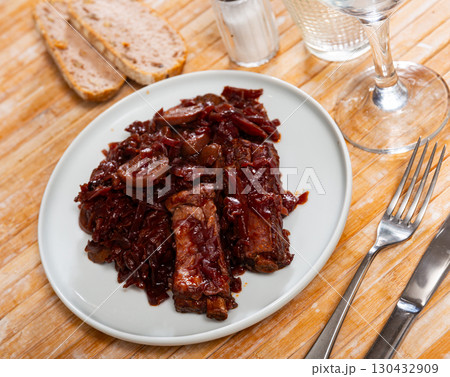 Stewed red cabbage with pork ribs on plate closeup 130432909
