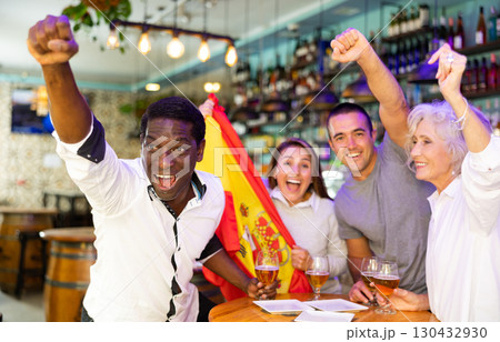 Happy fans celebrating the victory of Spanish team in bar 130432930
