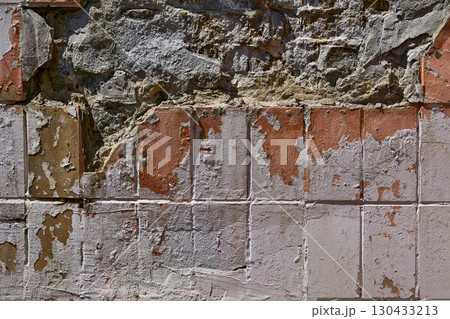 Old crumbling wall with red tiles.Abandoned space Old crumbling wall with red tiles.Abandoned space 130433213