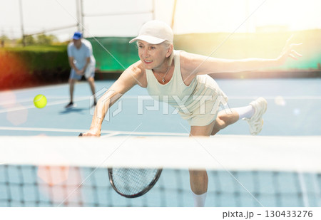 Senior woman plays tennis 130433276