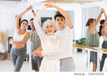 Elderly woman and young boy dancing as couple 130433281