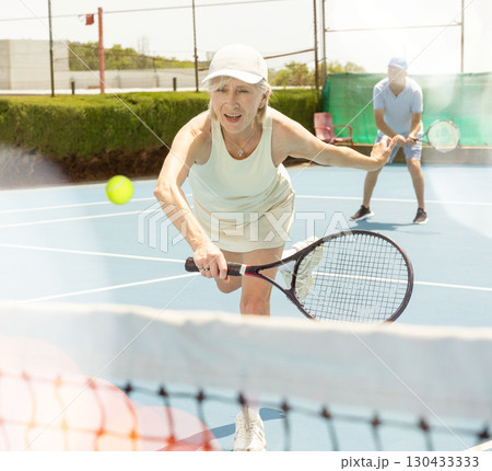 Senior woman plays tennis 130433333