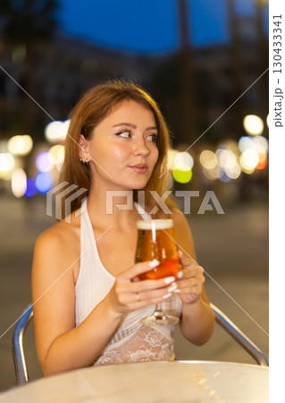 Young woman drinking beer in cafe in Royal Square (Placa Real), Barcelona 130433341