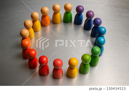 Top view of colorful wooden peg figures standing in circle on light background symbolizing equity inclusion values. 130434523