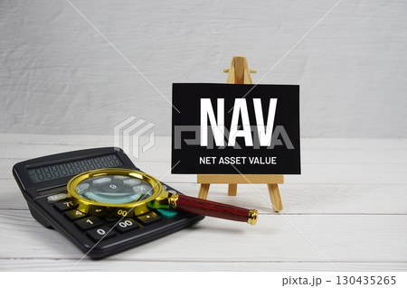 NAV abbreviation of Net Asset Value text with magnifying glass and calculator on wooden background NAV abbreviation of Net Asset Value text with magnifying glass and calculator on wooden background 130435265