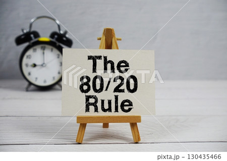 The 80/20 Rule text with easel and alarm clock on wooden background 130435466